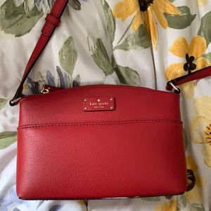Red Kate spade crossbody shoulder bag with adjustable strap and pockets
